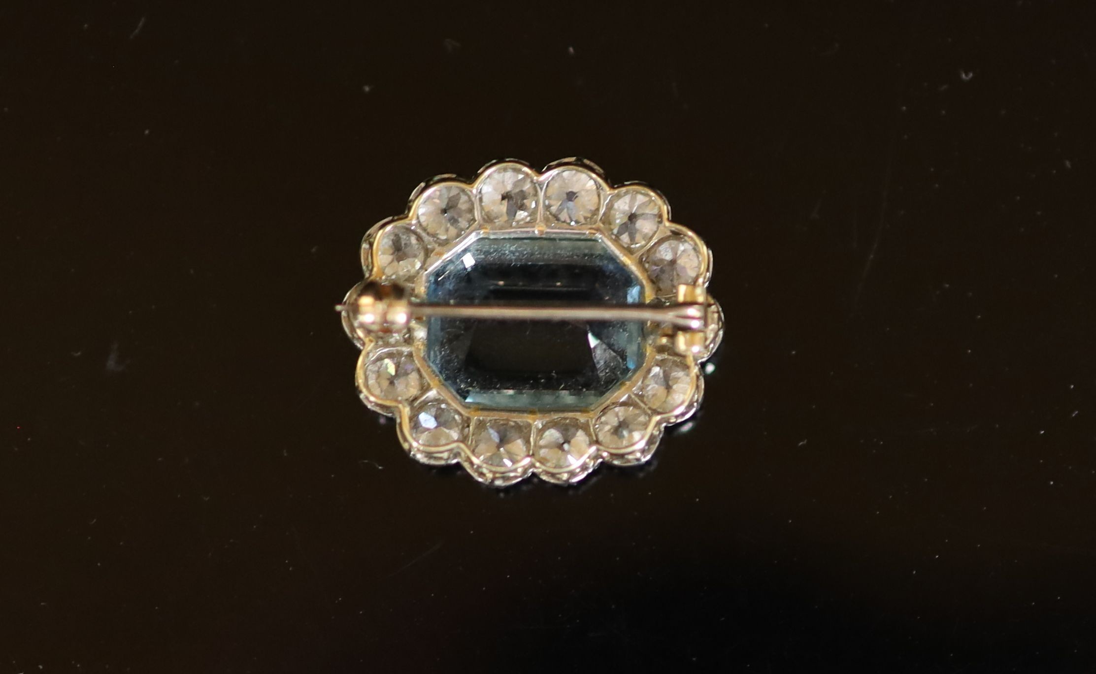 A gold and silver, aquamarine and diamond set oval cluster brooch